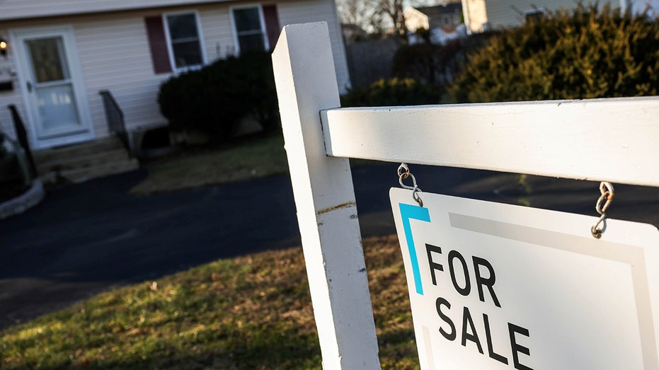 A for sale sign in front of a home